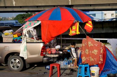 Pathum Thani is an industrial area North of Bangkok and It's main road is flooded. It's bordered on its South by the Rangsit canal along which a 20+ km sandbag wall was build to stop the water going to Bangkok. Living off the back of a pickup on the expressway.